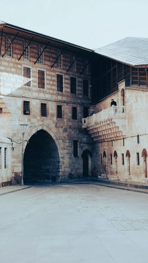 the large stone building has multiple archways and windows