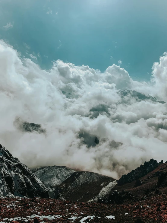 clouds over the mountains in the day time