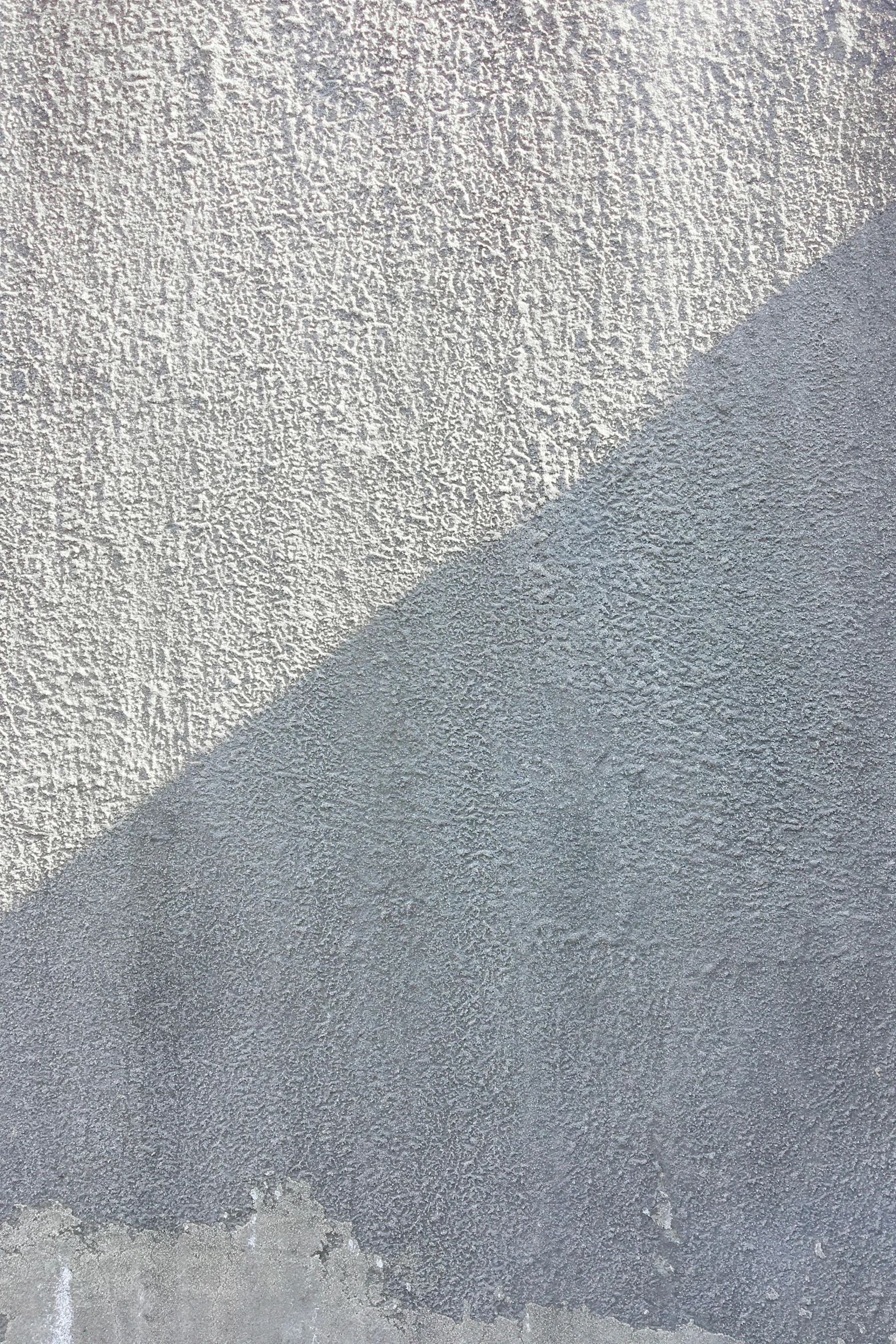 the shadow of the umbrella is reflected in the wet sidewalk