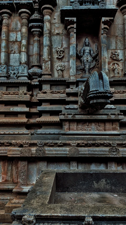 old and worn statue displayed in a stone building