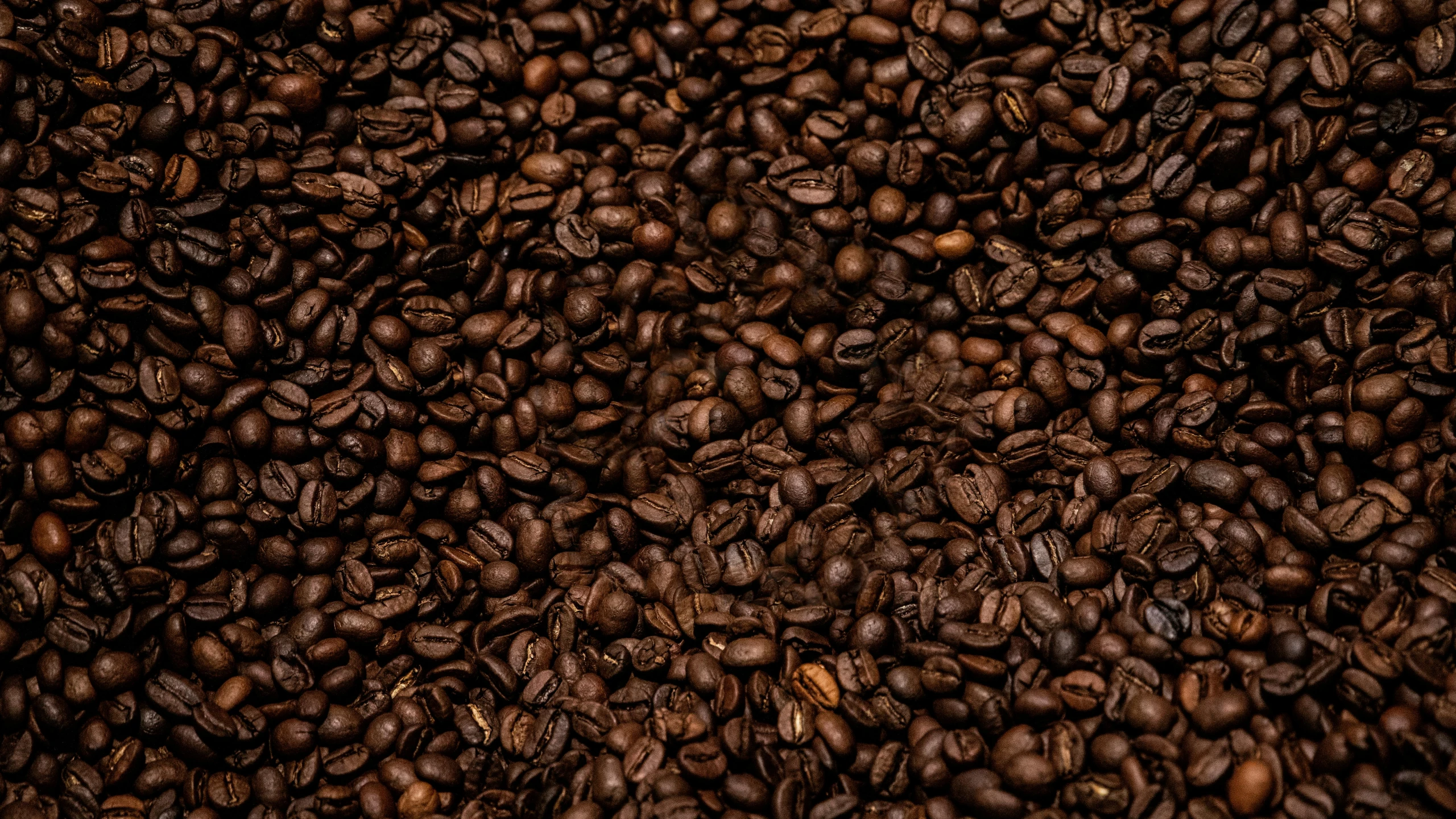 large quantities of coffee beans are scattered in a pile