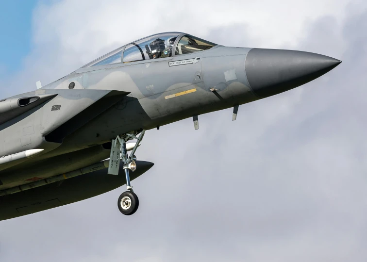 an aircraft with a military style pilot standing in the air