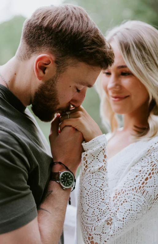 a young couple is standing together and smiling