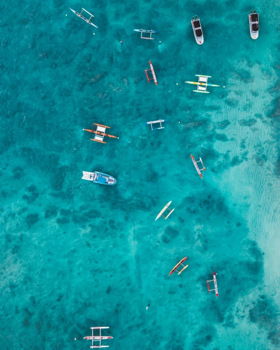 the waters are empty and there are small boats floating on the water