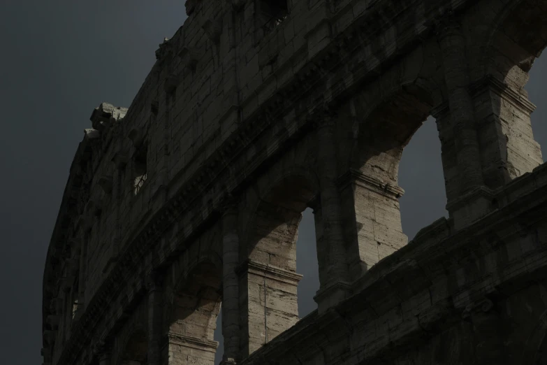 an arch in a roman building with moon shining