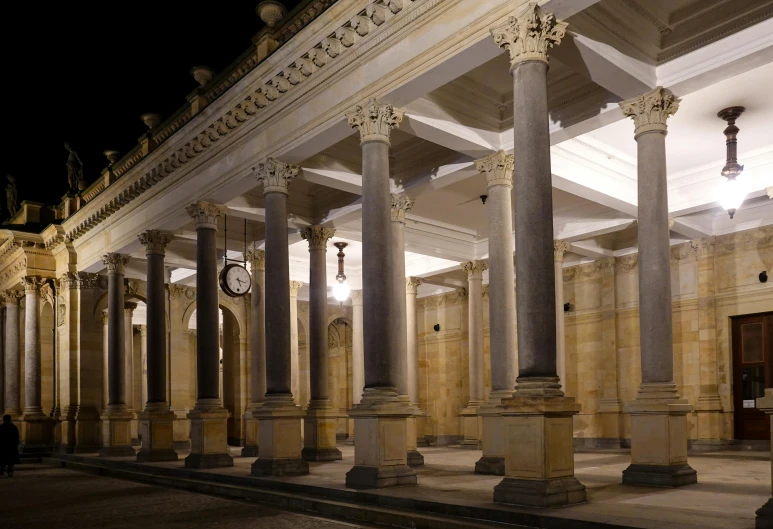 the pillars and clock are in a large building