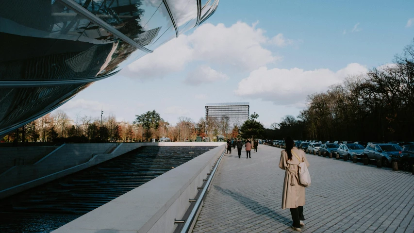 a woman is walking on a brick sidewalk