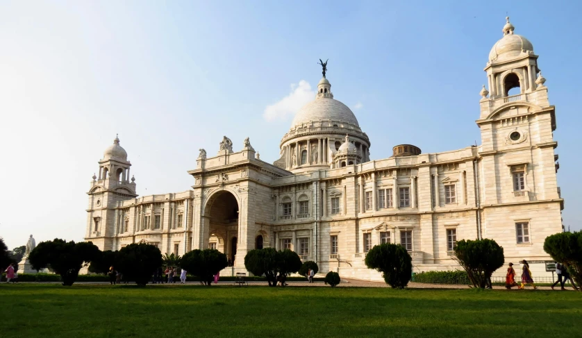 a very large white building with two towers and arches