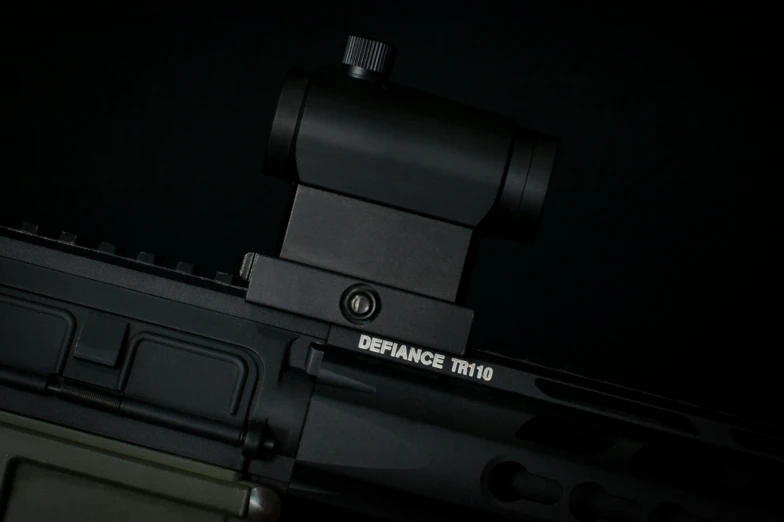 the scope is being mounted to the back of a rifle