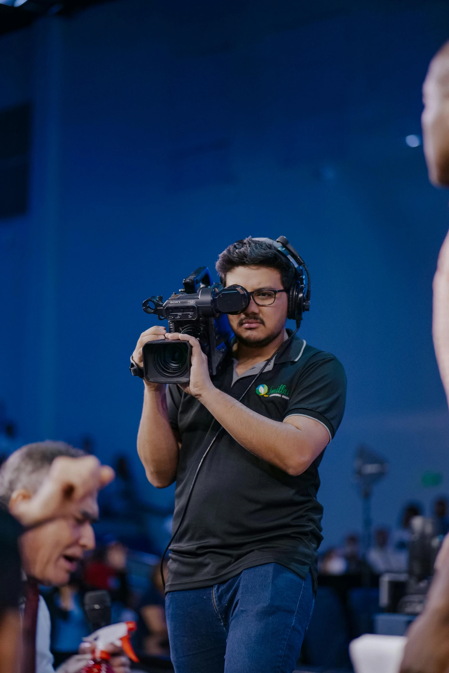 a man in a black shirt holding a camera