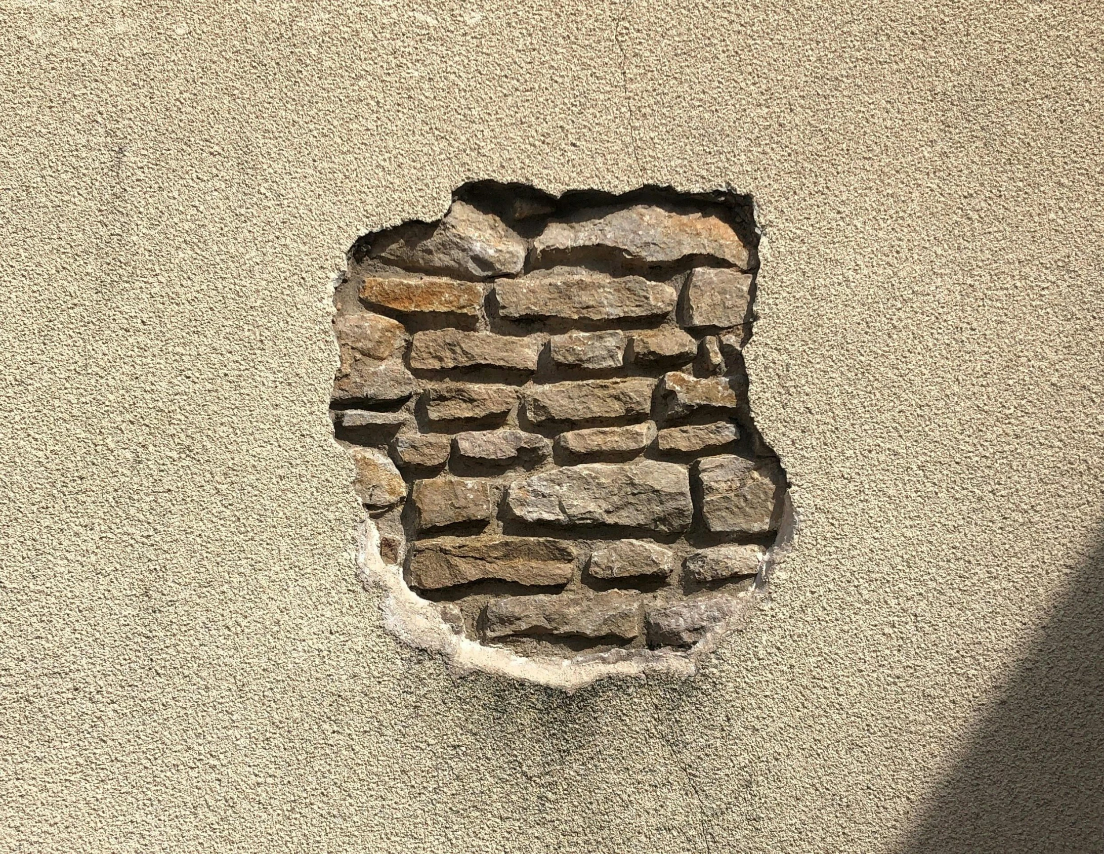 a small window in the side of a brick wall