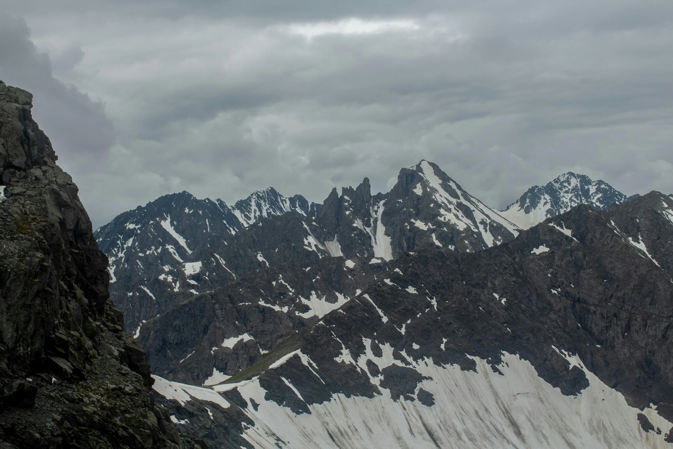 a person sitting on top of a snowy mountain