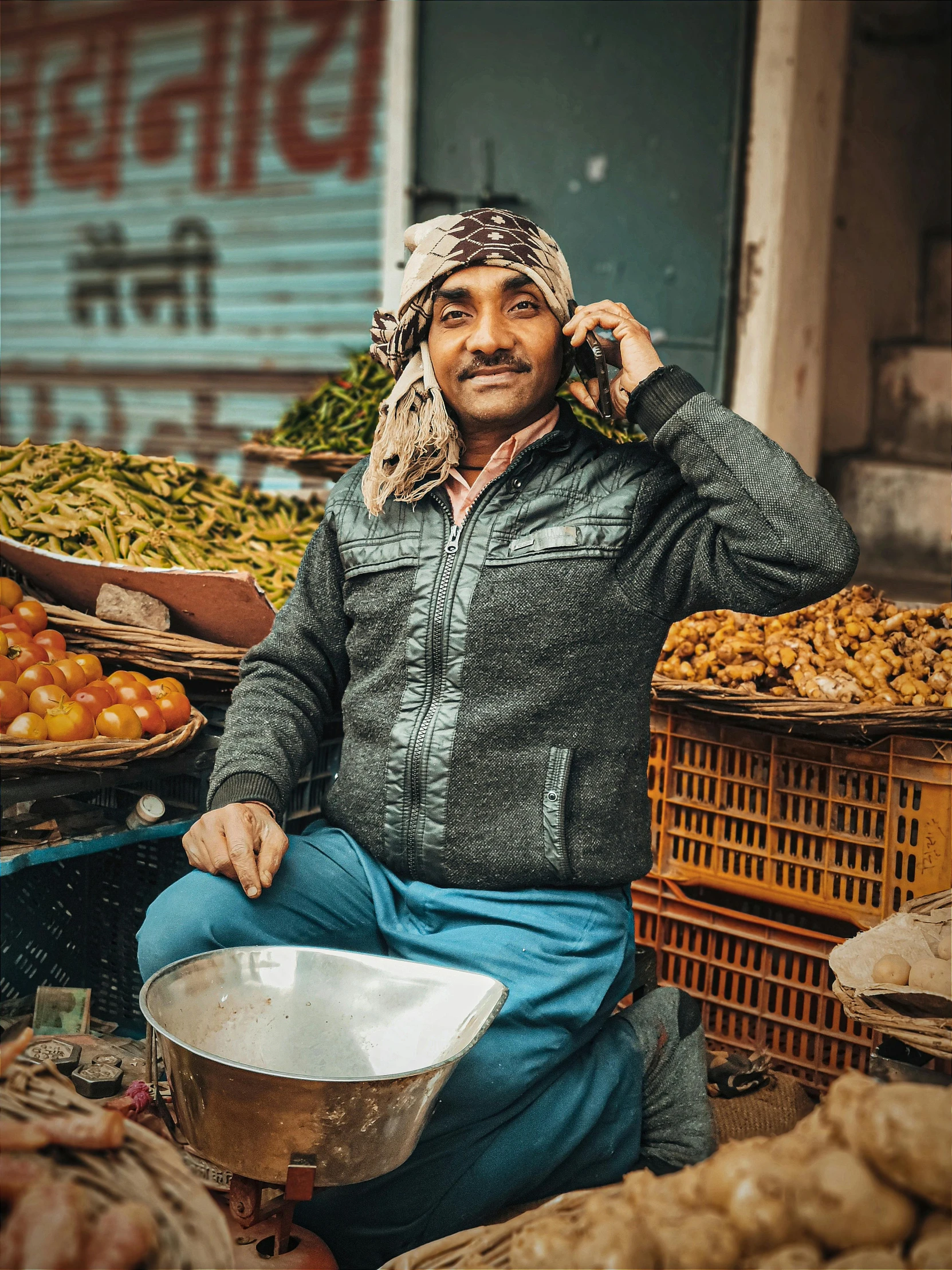 a man in blue jeans talking on a cell phone