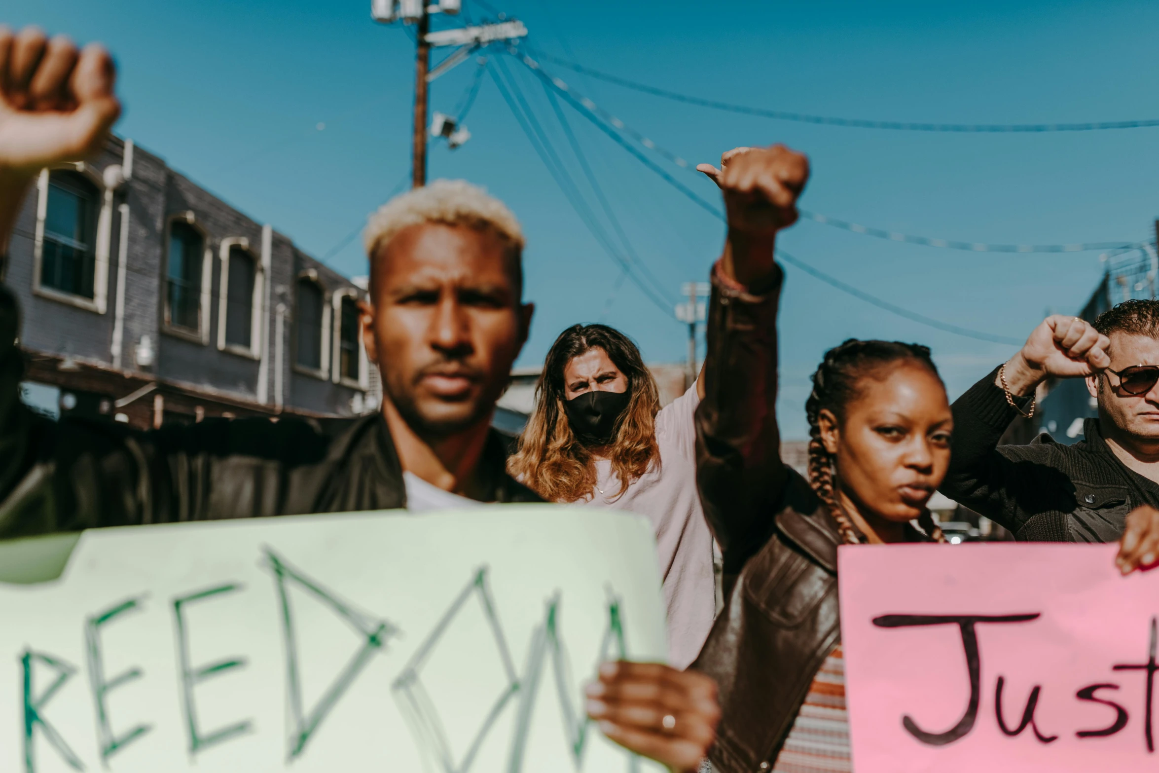 a man with his fist raised and signs in front of him