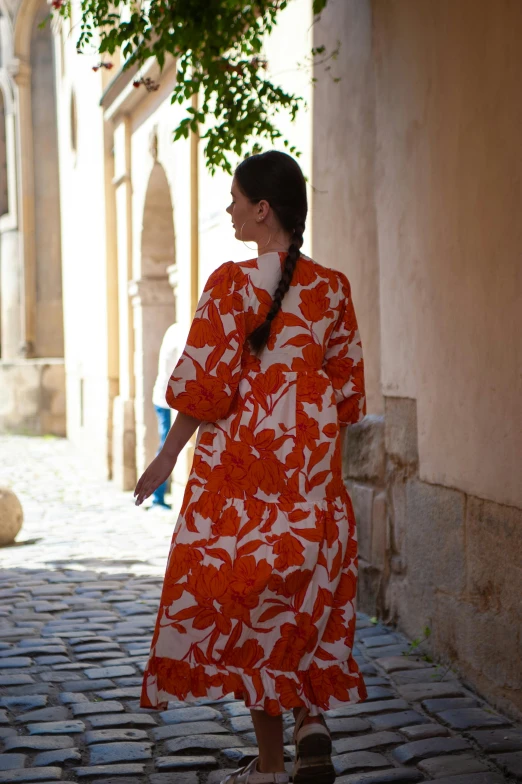 the woman is walking through a building and carrying soing