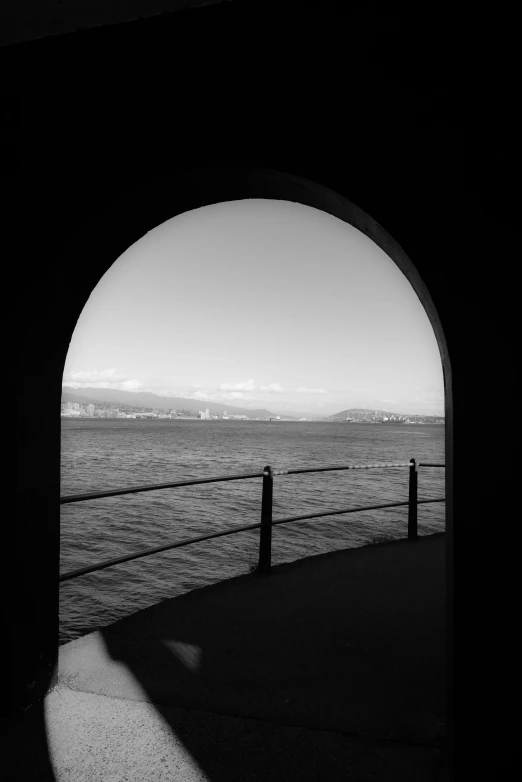 a view from under an arch onto the ocean and the ocean