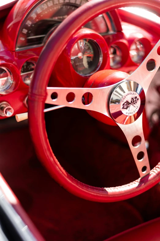 the interior of a red sports car with its steering wheel