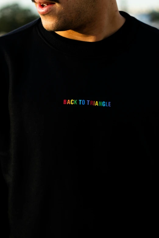 man wearing sunglasses with the word back to triangle on his shirt