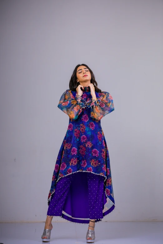 the young woman is dressed in a colorful dress and jewelry