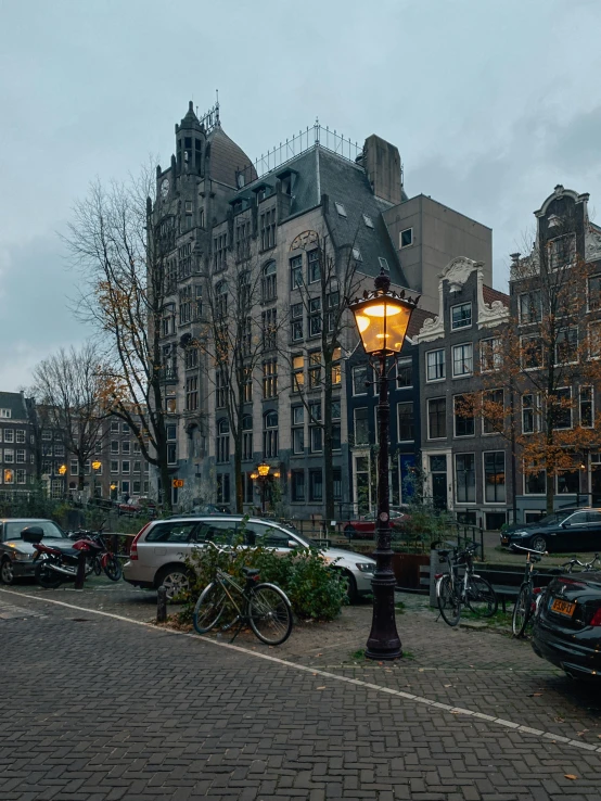 the bikes are parked next to the street lamp