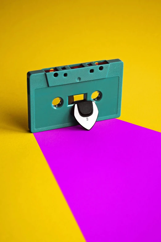 there is a music cassette that has been placed on a colorful surface