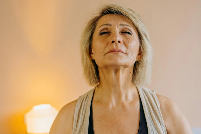 a woman who is sitting on her bed and making faces