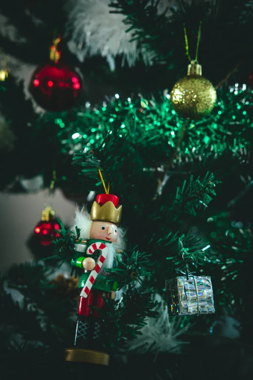 christmas ornaments hanging from the tree in a room