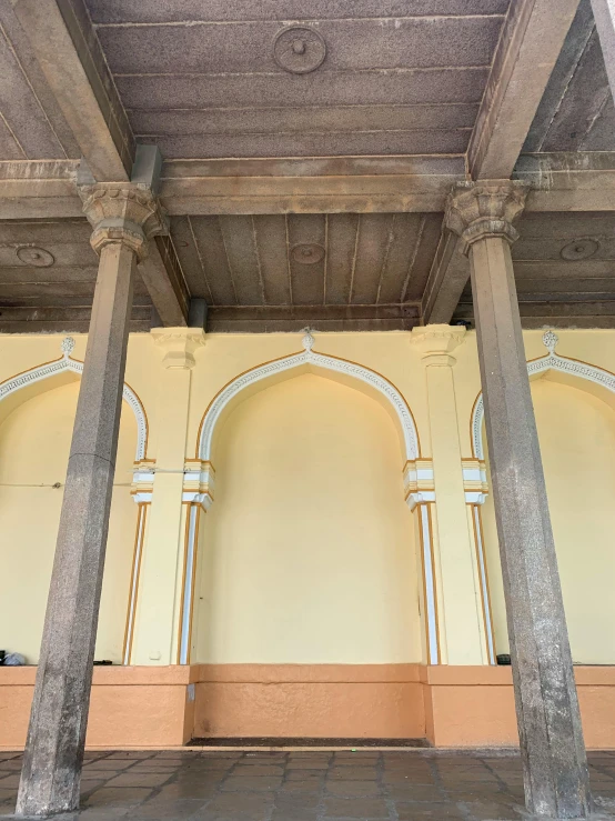 there is a wall with arches and pillars