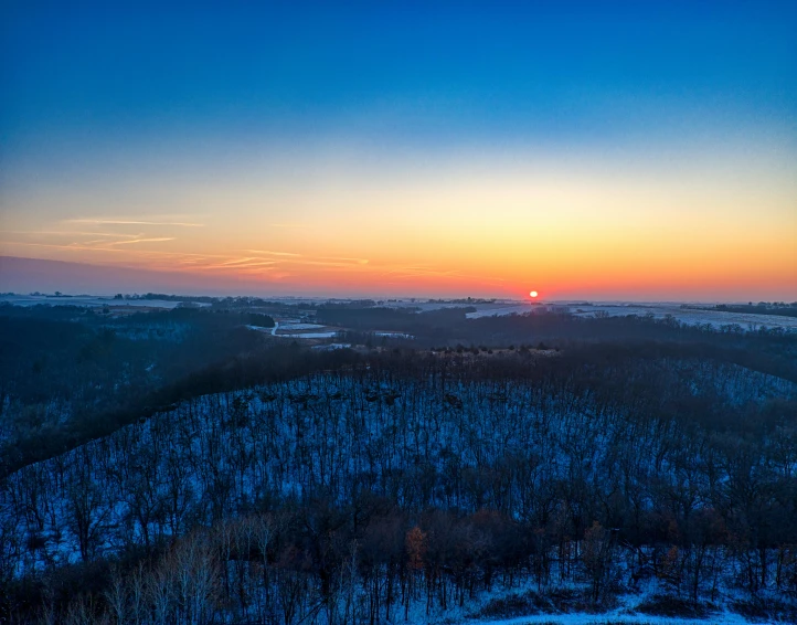 an orange, red and blue sky in the distance