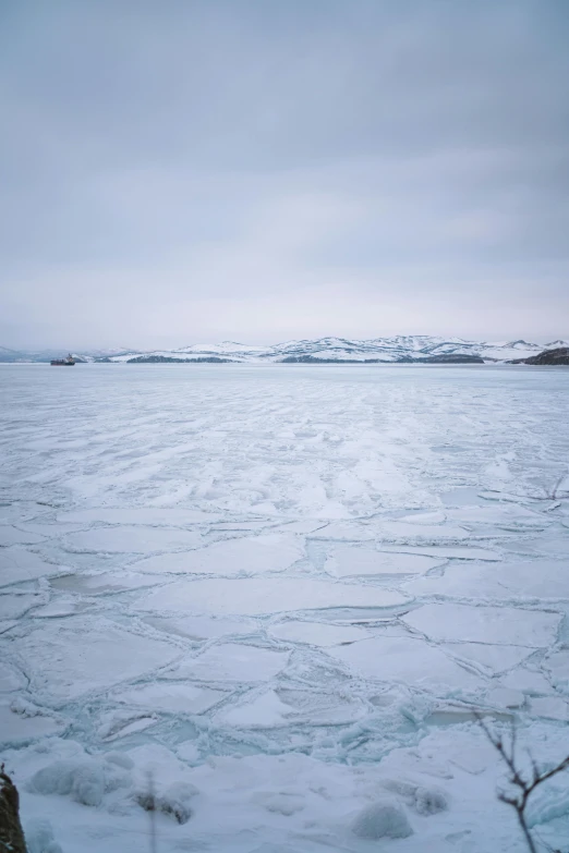 a frozen lake with large waves on the water