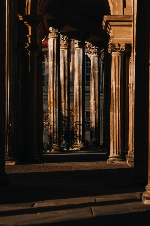 a couple of pillar stands sitting outside of an arch