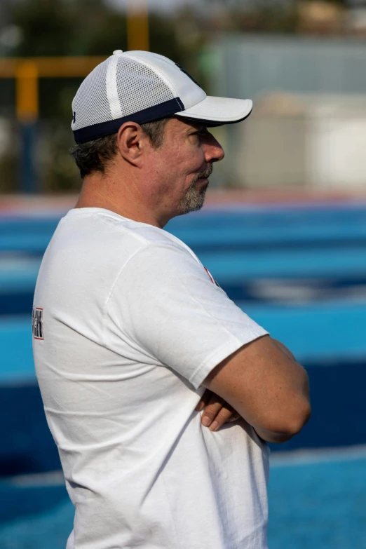 man wearing white and blue hat standing outside