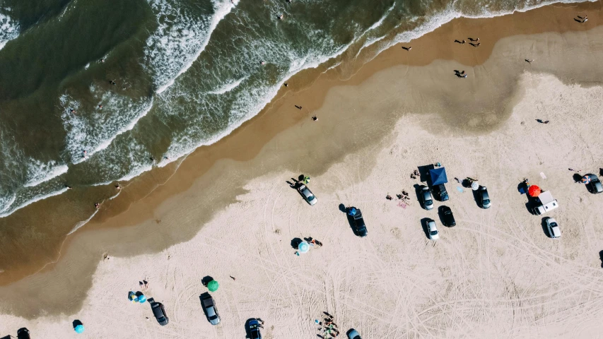 a group of surfers on beach with surfboards