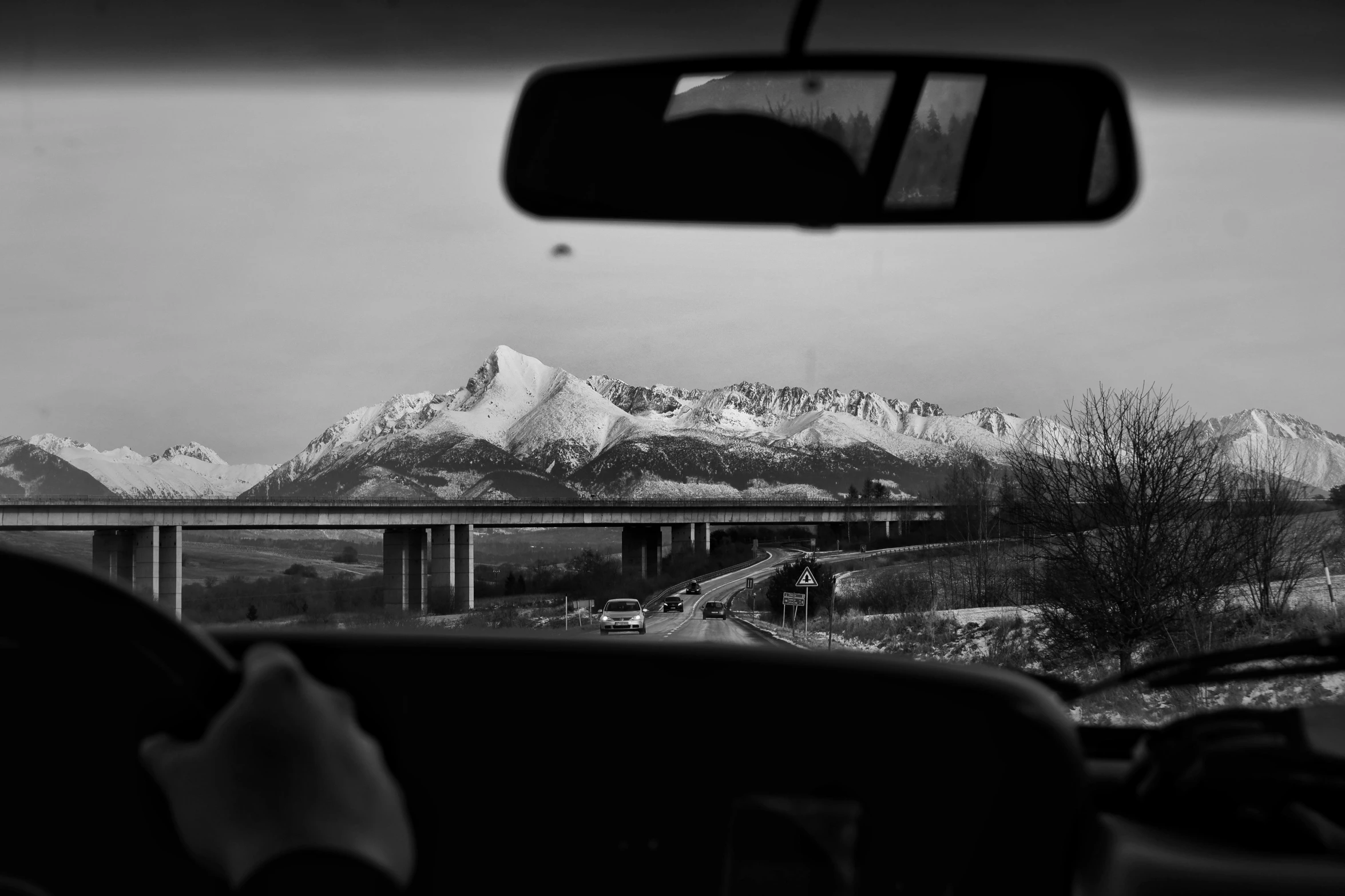 the windshield of a car near a bridge