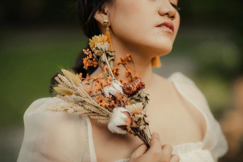 a close up of a woman with dried flowers in her hair