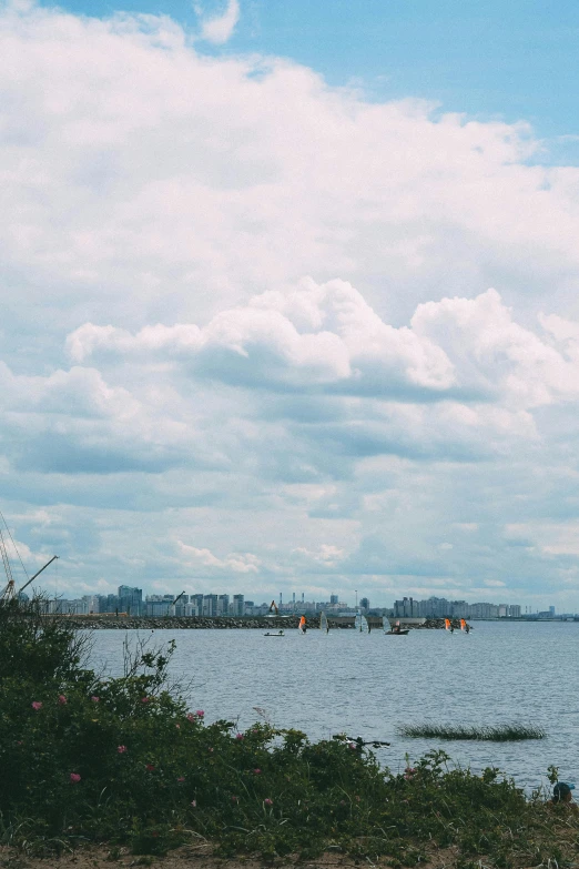 view of the ocean with sail boats in the distance