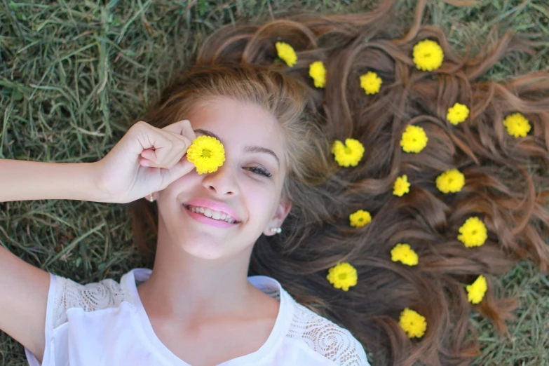 a  laying on the grass with yellow flowers