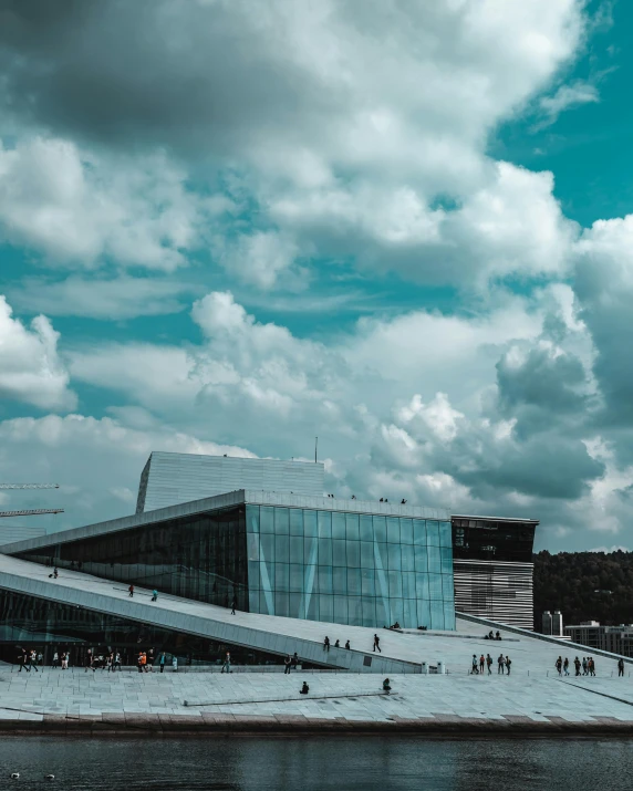 a cloudy day at the dock with people walking and sitting