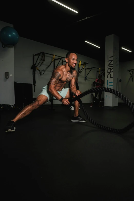 a man is doing an intense battle rope workout