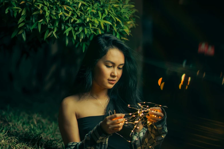 woman wearing black and holding sparkler outdoors