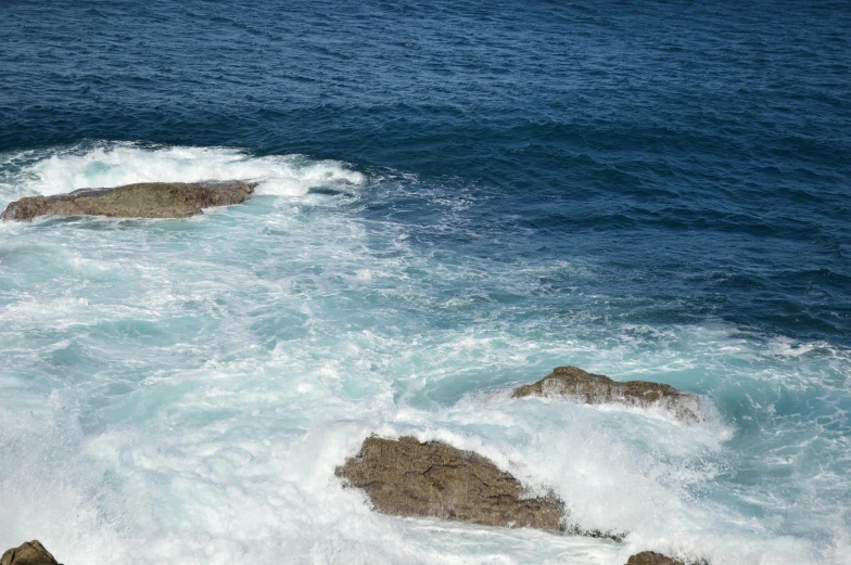 a large body of water near some rocky shore