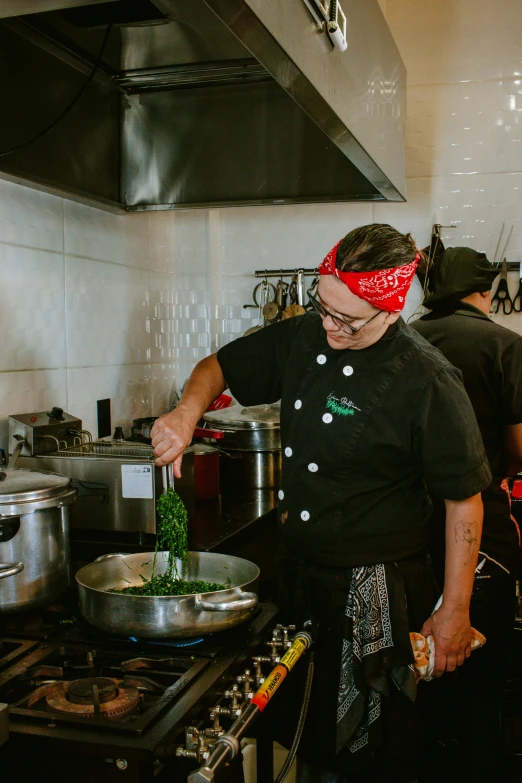 a man in a black shirt is in a kitchen