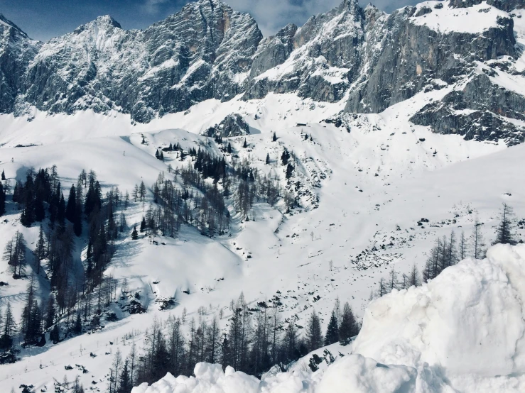 two skiers ride down a hill in the snow