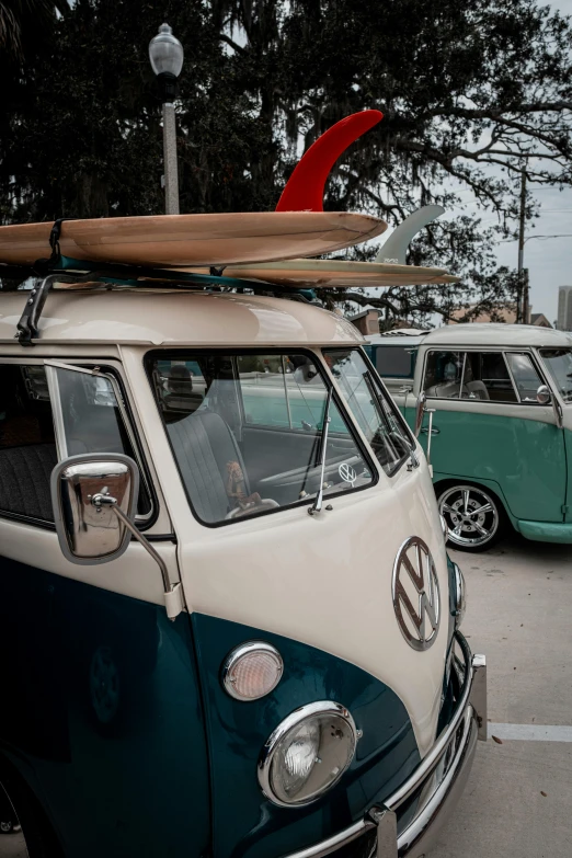 an old vw bus with a surfboard on top of it