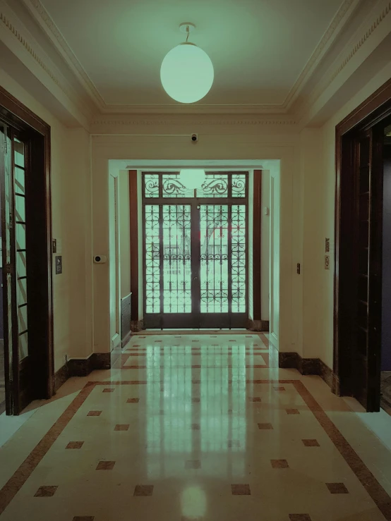 an empty hallway with tiled floors and several doors