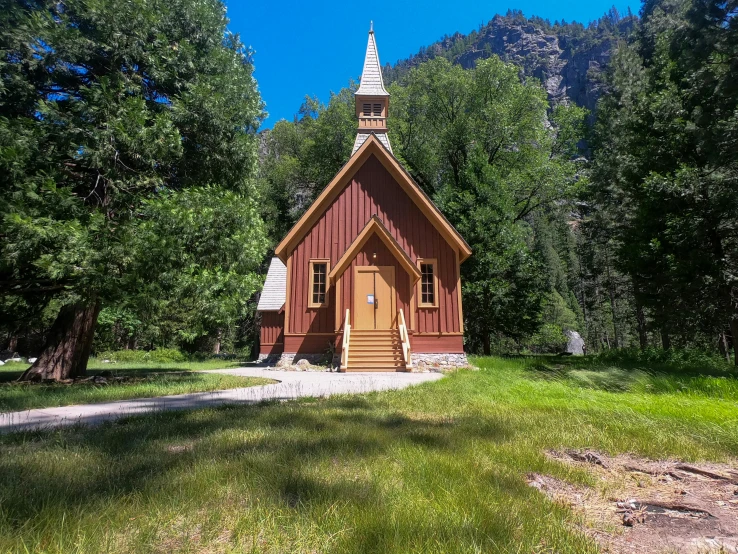 a red and wooden chapel in the woods