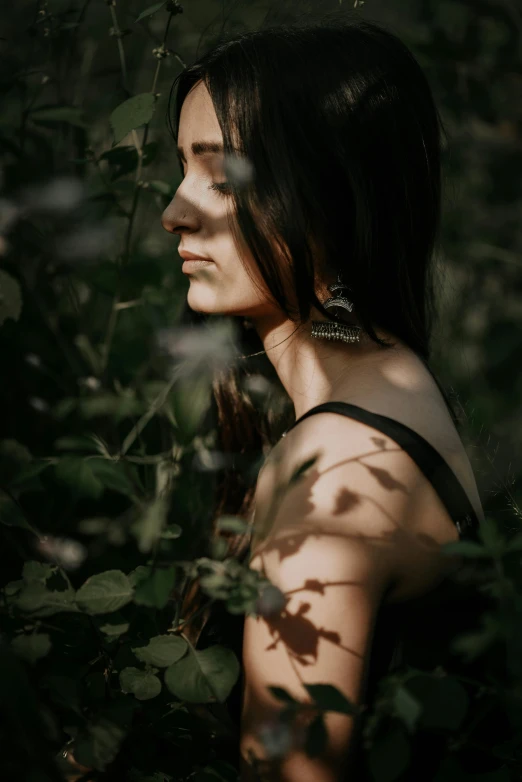 a woman with long hair and green eyes stares into the distance