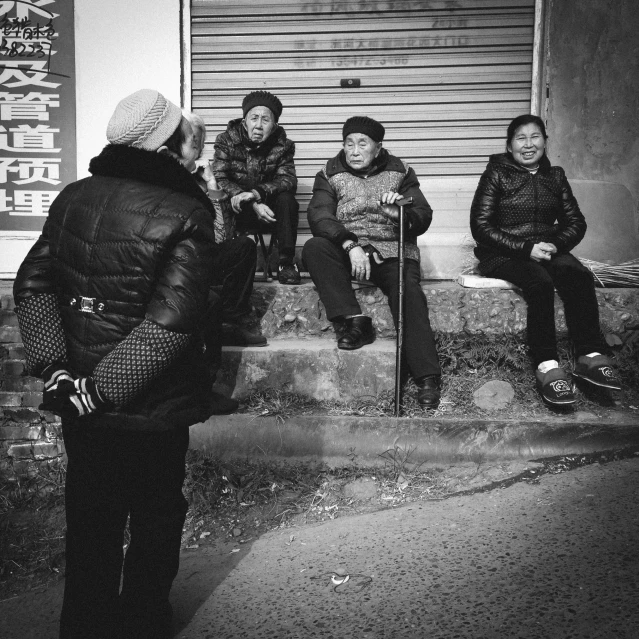 five people in a group sitting on a set of steps