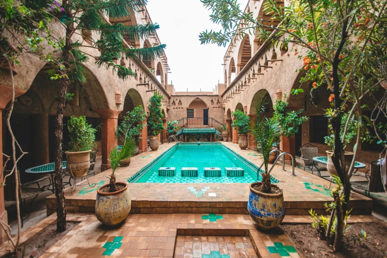 a big long pool and some trees in the middle