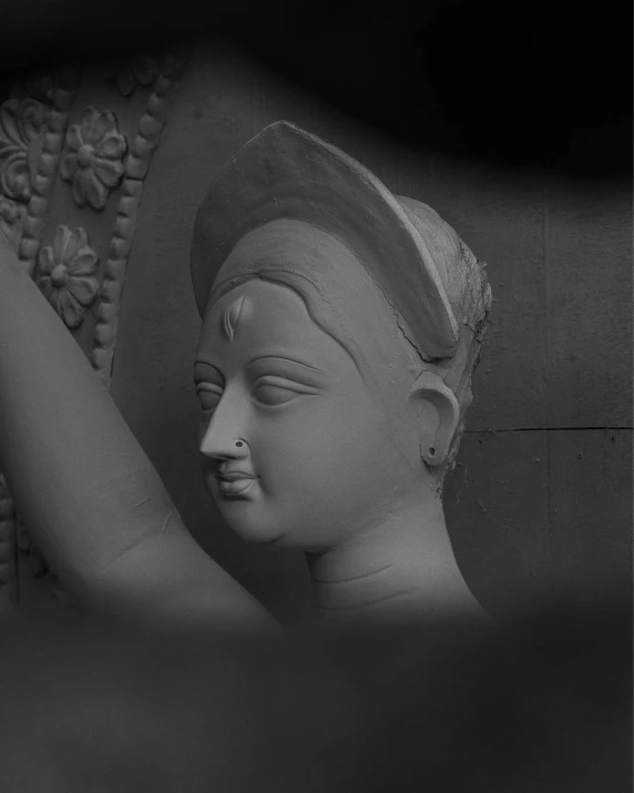a black and white image of a head statue with its eyes closed